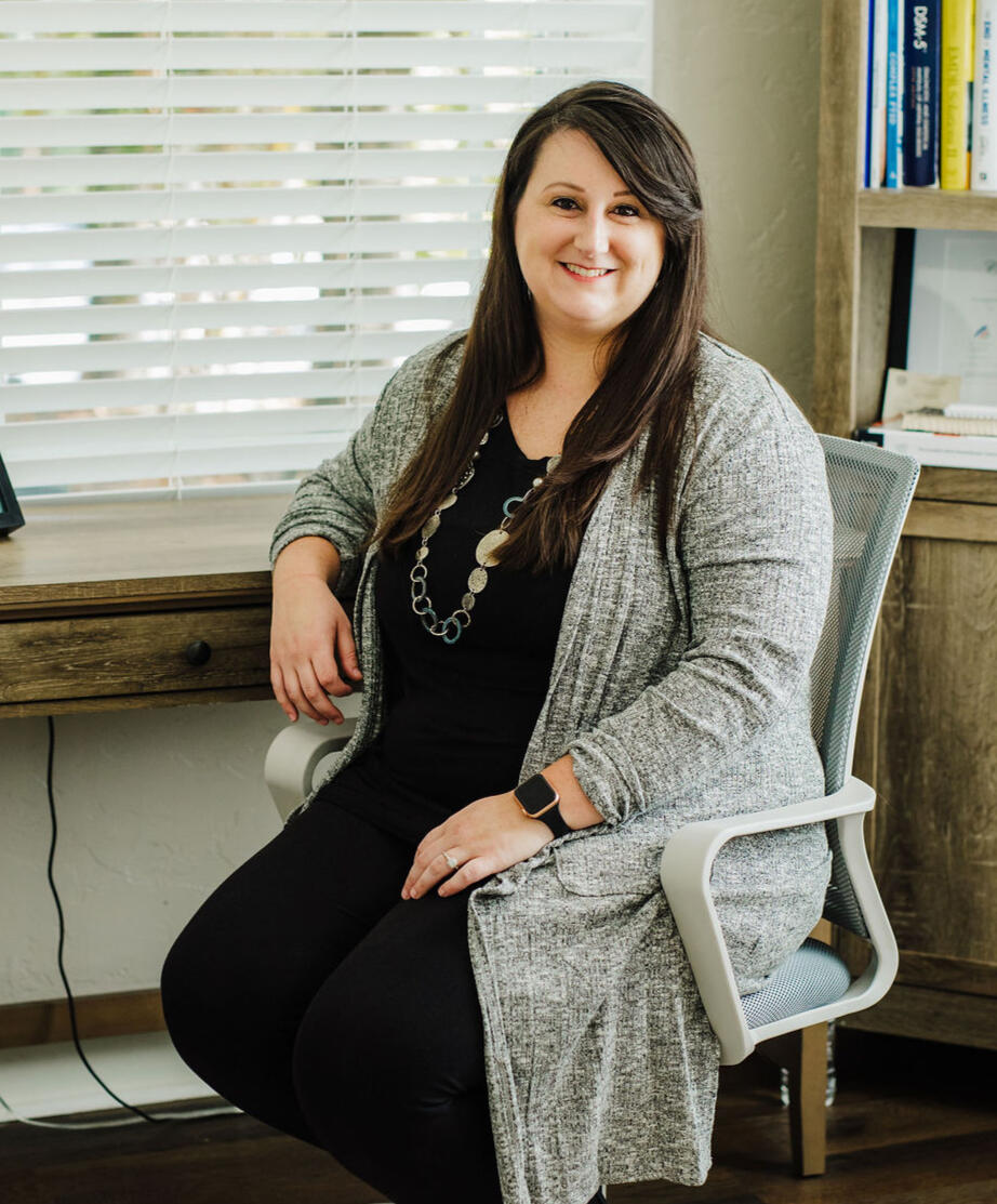 Megan Korthals sitting at her desk